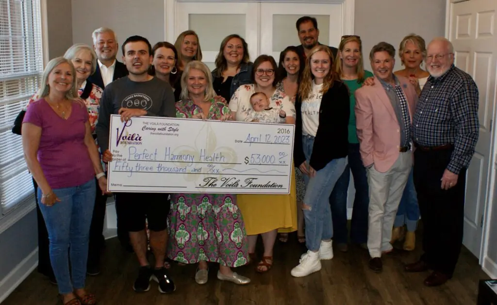 The Voila Foundation Presenting Perfect Harmony Health With Their Check In 2023