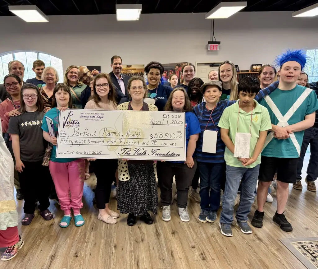 The Voila Foundation Presenting Perfect Harmony Health With Their Check
